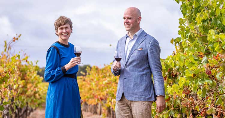 woman and man hold glass of red wine in the winery at Zema Estate Coonawarra
