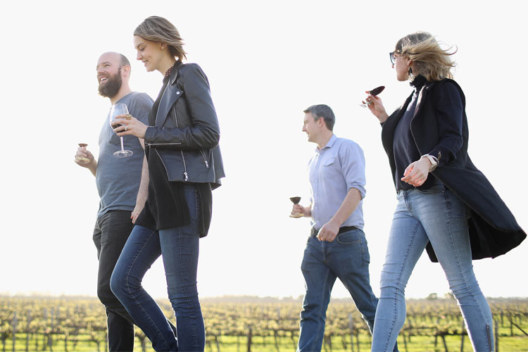 People walking the Coonawarra Walking Trail with wine glasses