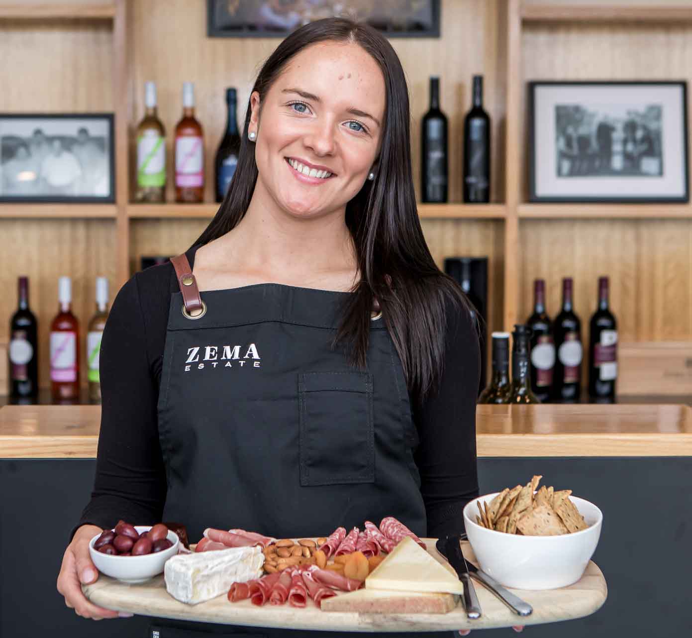 lady holds large platter in cellar door