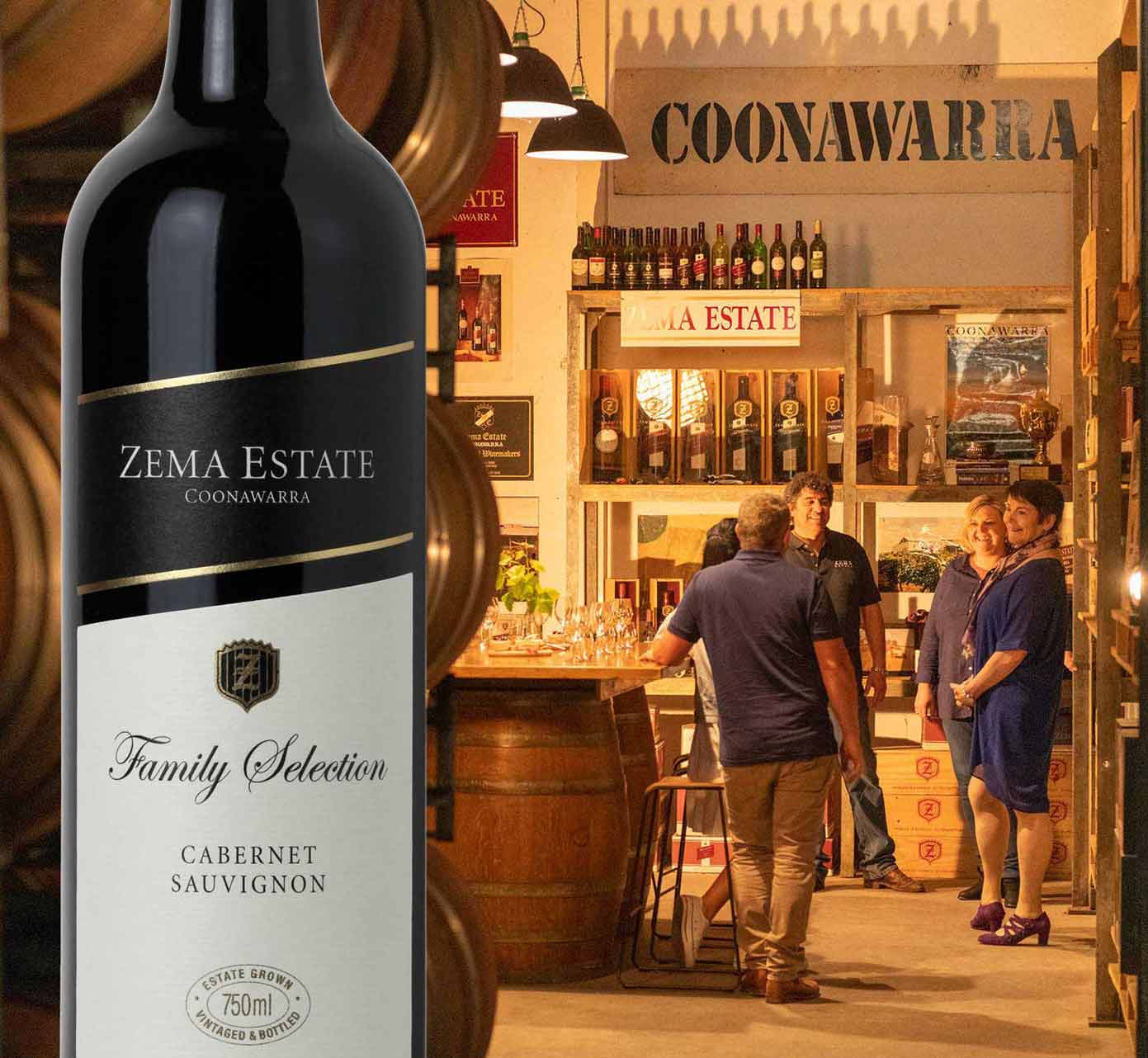 people walk down a dimly lit winery cellar for tasting
