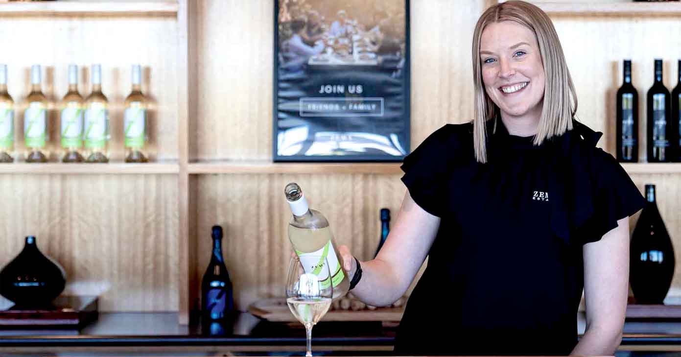 lady pours wine at zema estate cellar door 