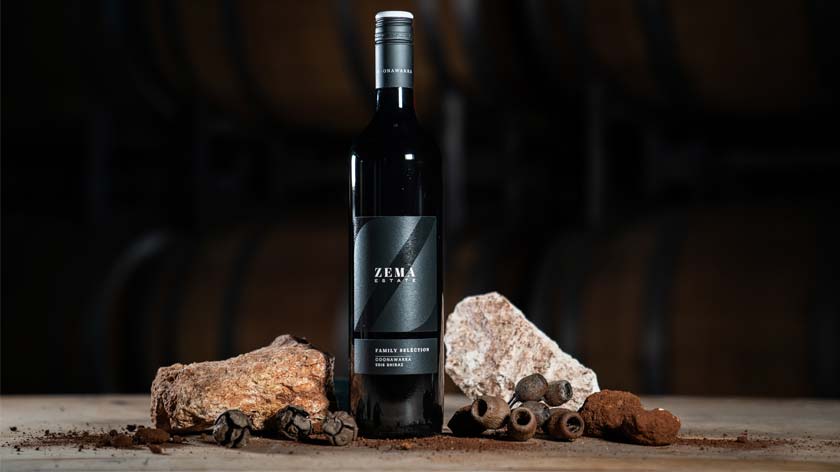 a bottle of family selection wine sits next to limestone rocks