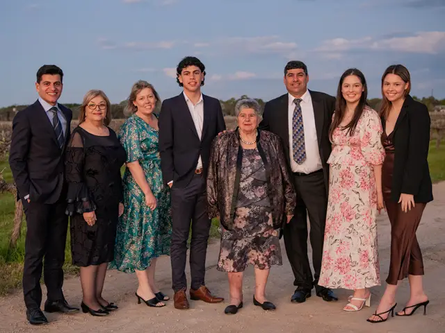 Zema family gather in front of vineyard for photo to celebrate 40 years of zema estate